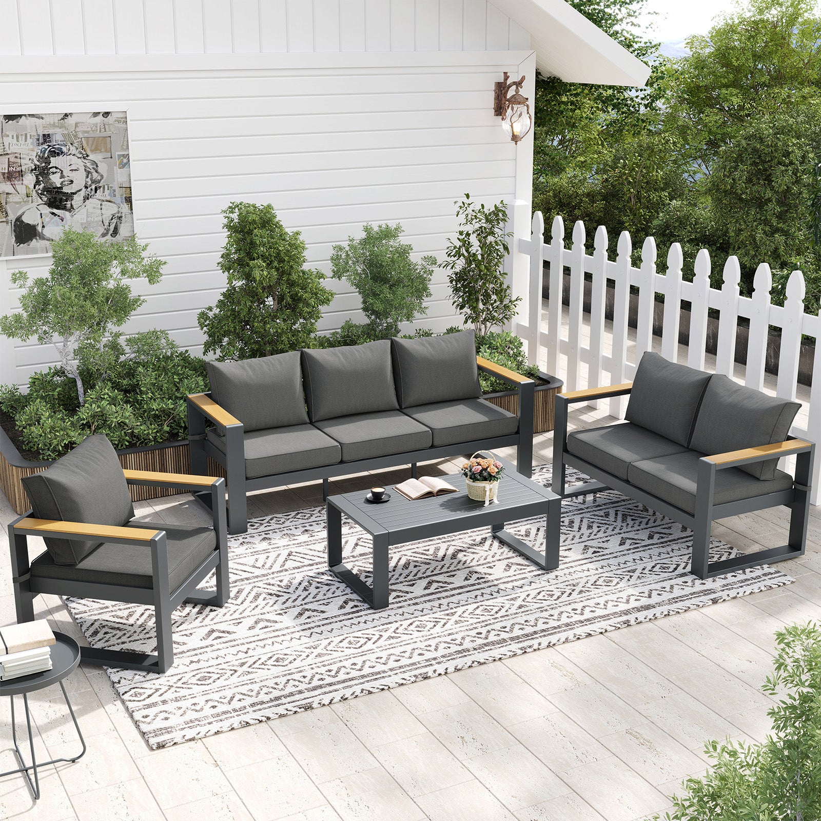Outdoor patio furniture set with gray cushions on a wooden deck.
